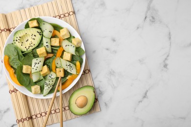 Photo of Tasty salad with tofu and vegetables served on white marble table, flat lay. Space for text