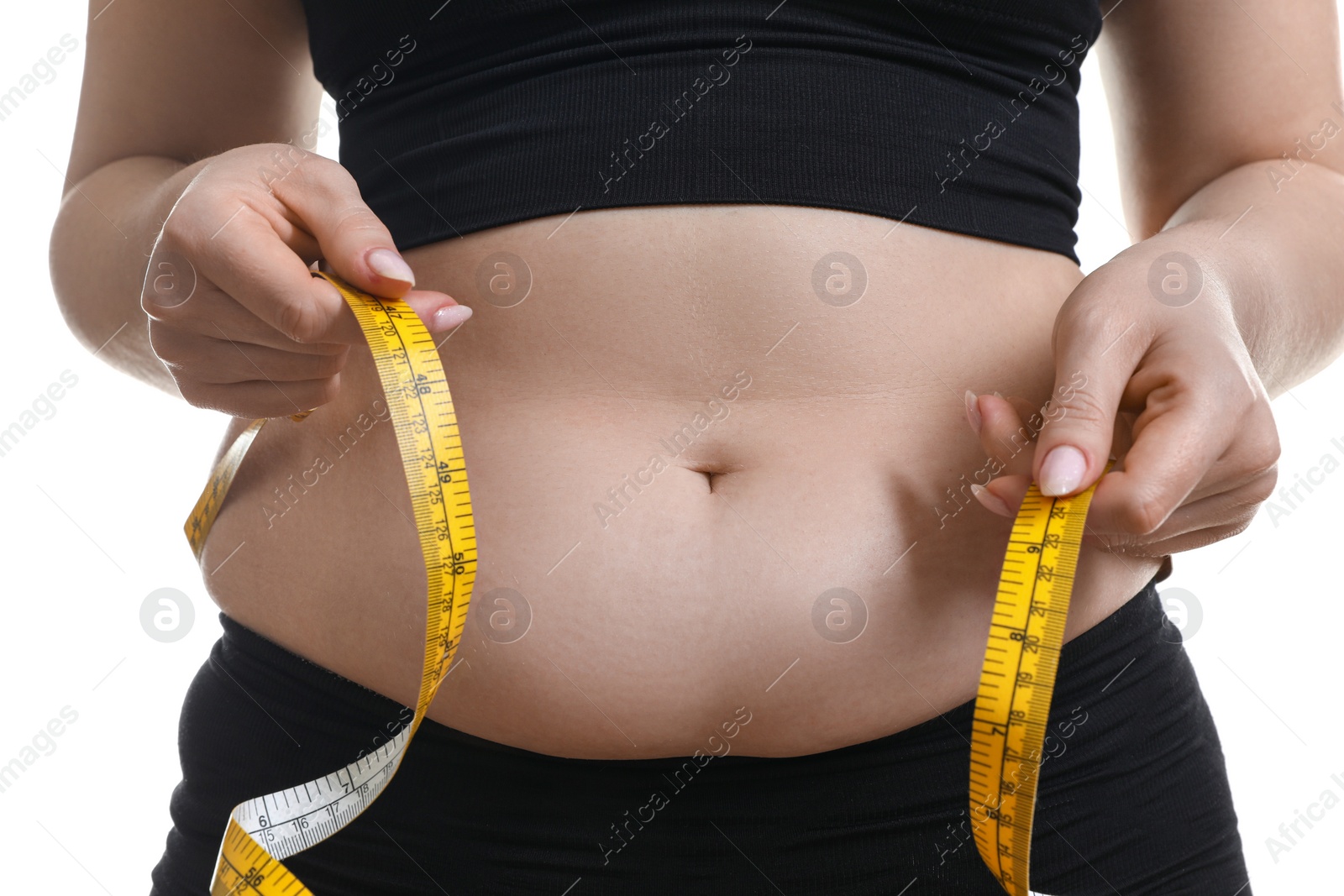 Photo of Woman measuring belly with tape on white background, closeup. Overweight problem