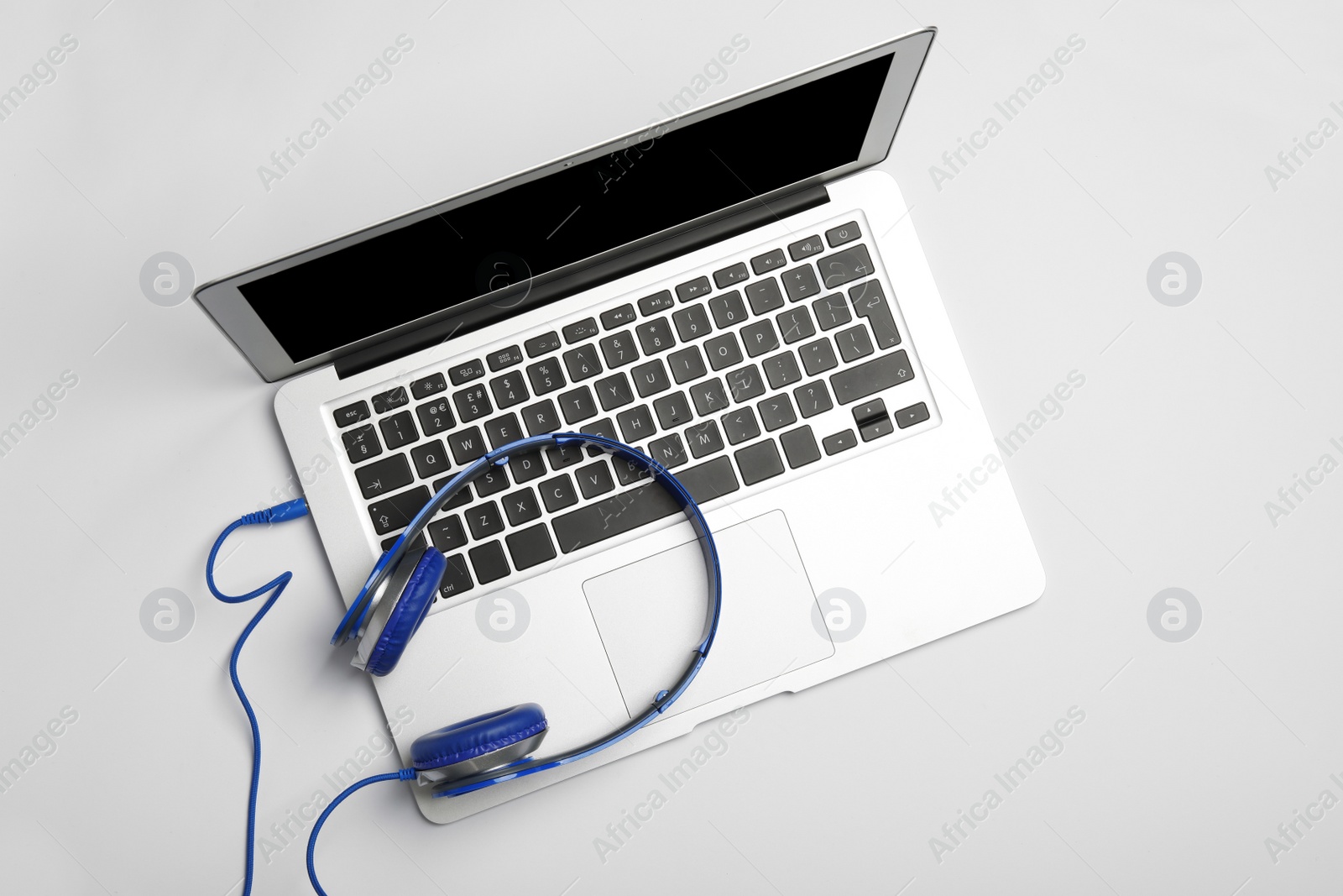 Photo of Modern headphones and laptop on white background, top view