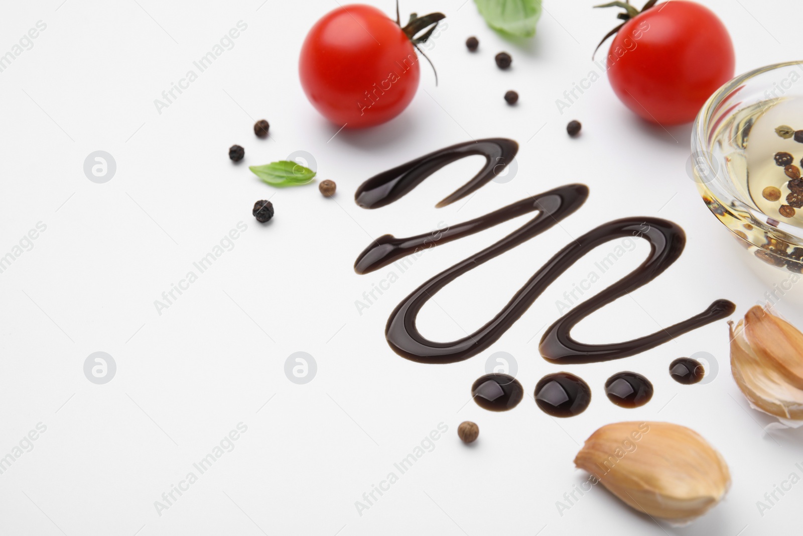 Photo of Organic balsamic vinegar and cooking ingredients on white background. Space for text