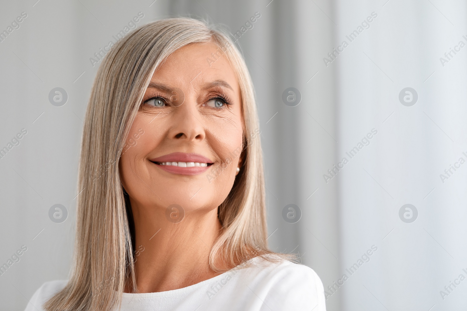 Photo of Portrait of beautiful middle aged woman indoors. Space for text