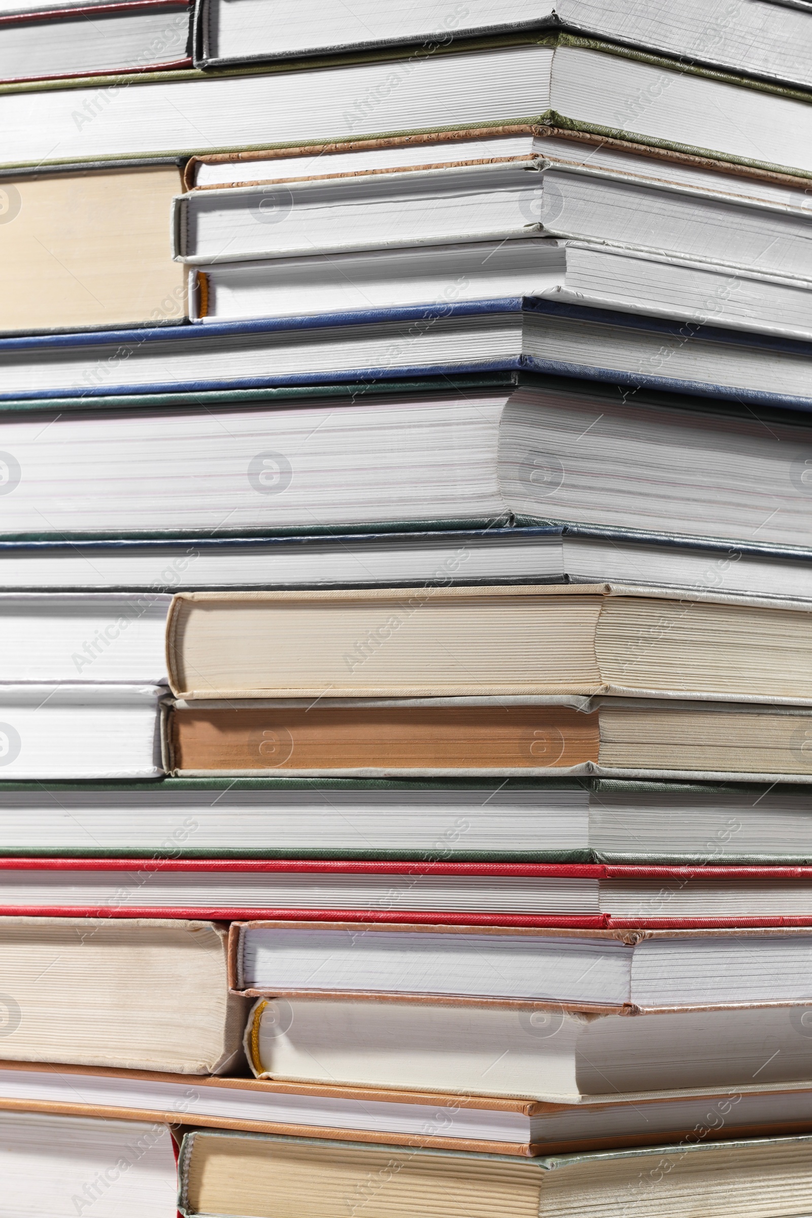 Photo of Stack of many different hardcover books as background, closeup