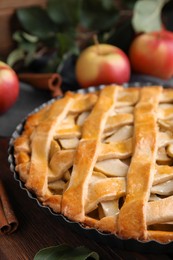 Photo of Delicious traditional apple pie on wooden table, closeup