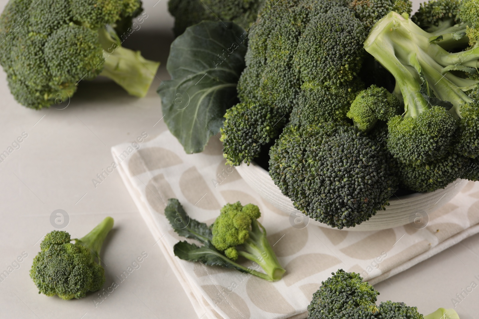 Photo of Fresh raw broccoli on white table, closeup