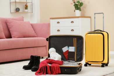 Photo of Modern suitcases packed for trip on floor indoors
