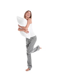 Photo of Young woman in pajamas embracing pillow on white background