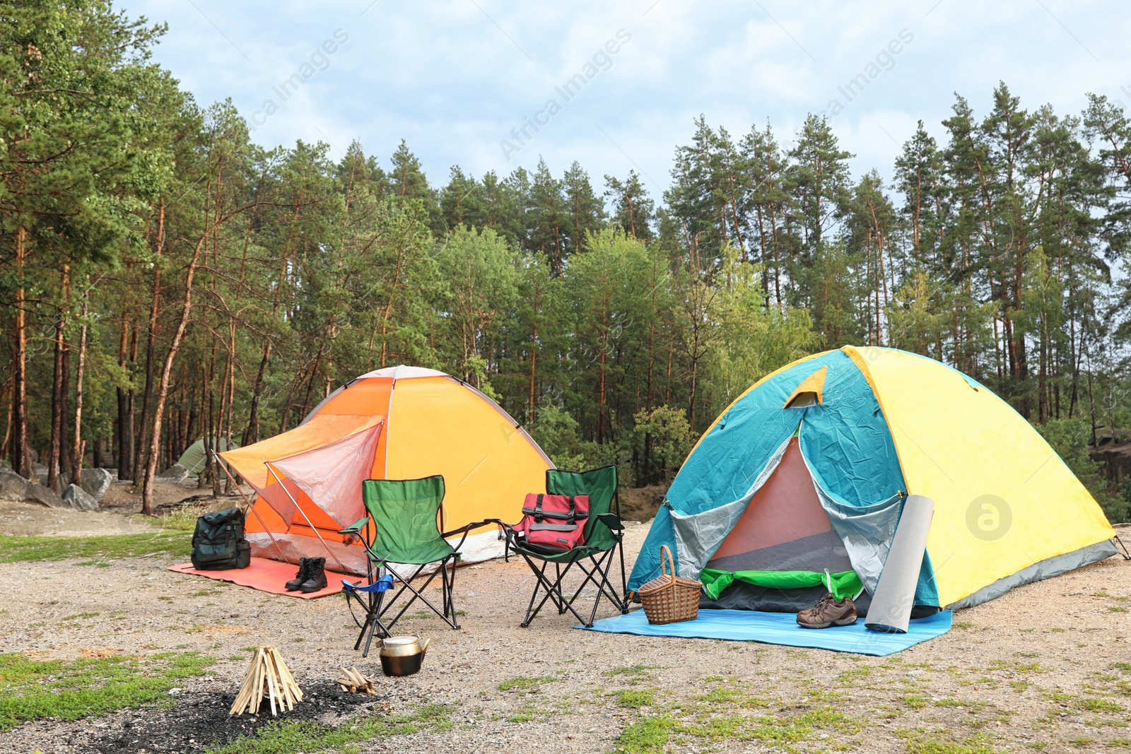 Photo of Camping tents and accessories in wilderness on summer day