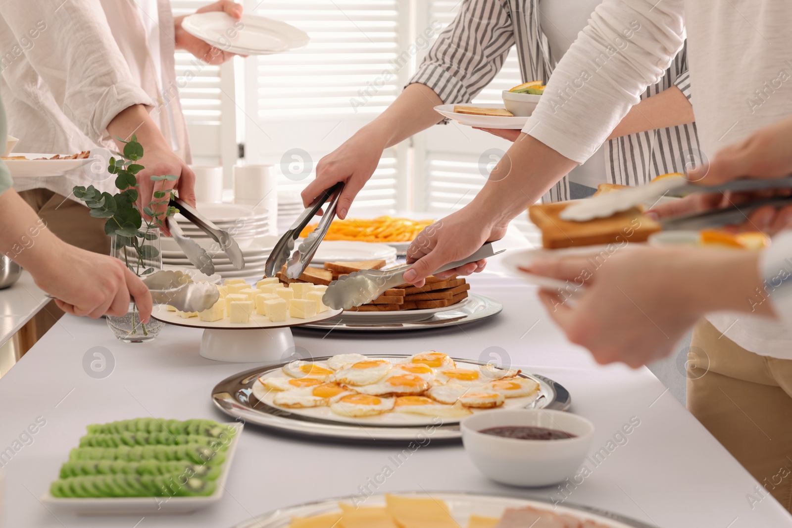 Photo of People taking food during breakfast, closeup. Buffet service