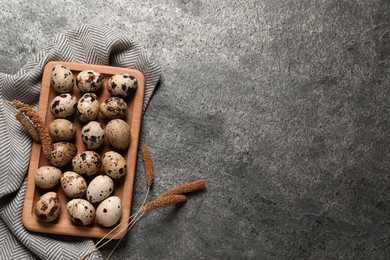 Photo of Flat lay composition with quail eggs on grey table. Space for text