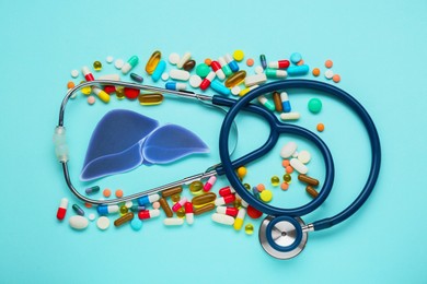 Photo of Paper liver, stethoscope and pills on turquoise background, flat lay. Hepatitis treatment