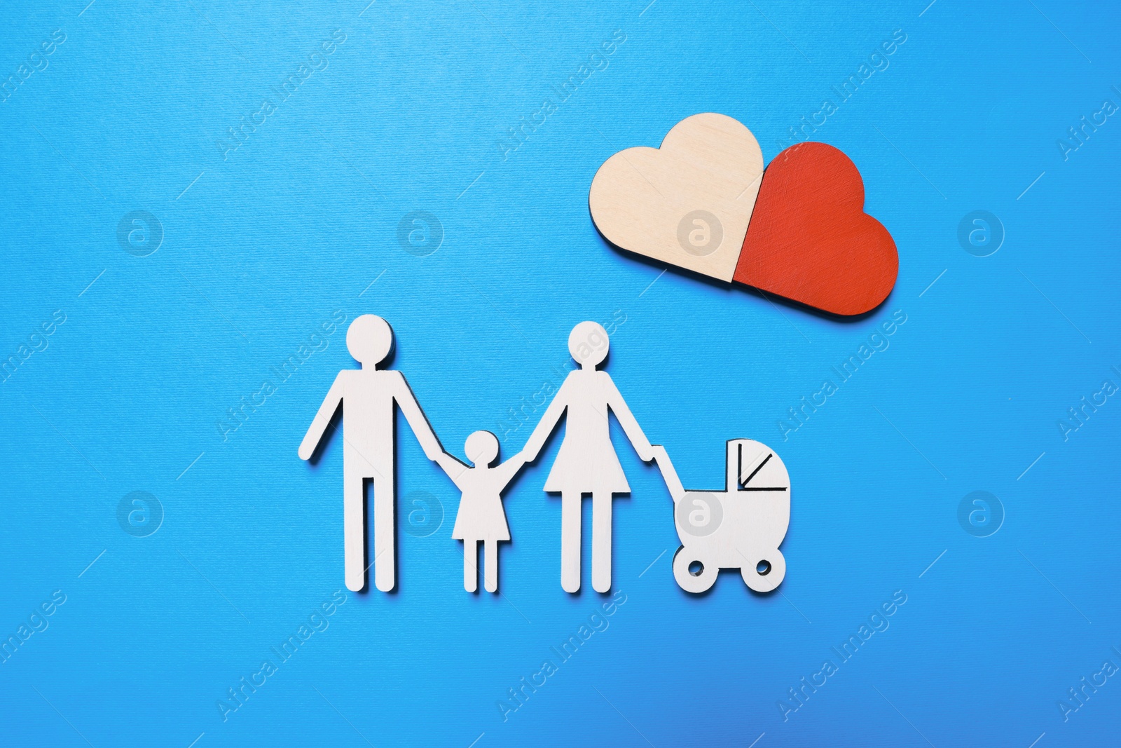 Photo of Figures of family and heart on light blue background, flat lay. Insurance concept