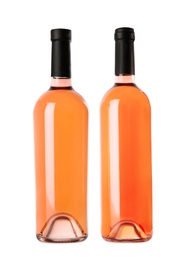 Photo of Bottles of delicious rose wine on white background. Mockup for design