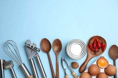 Photo of Cooking utensils and ingredients on light blue background, flat lay. Space for text