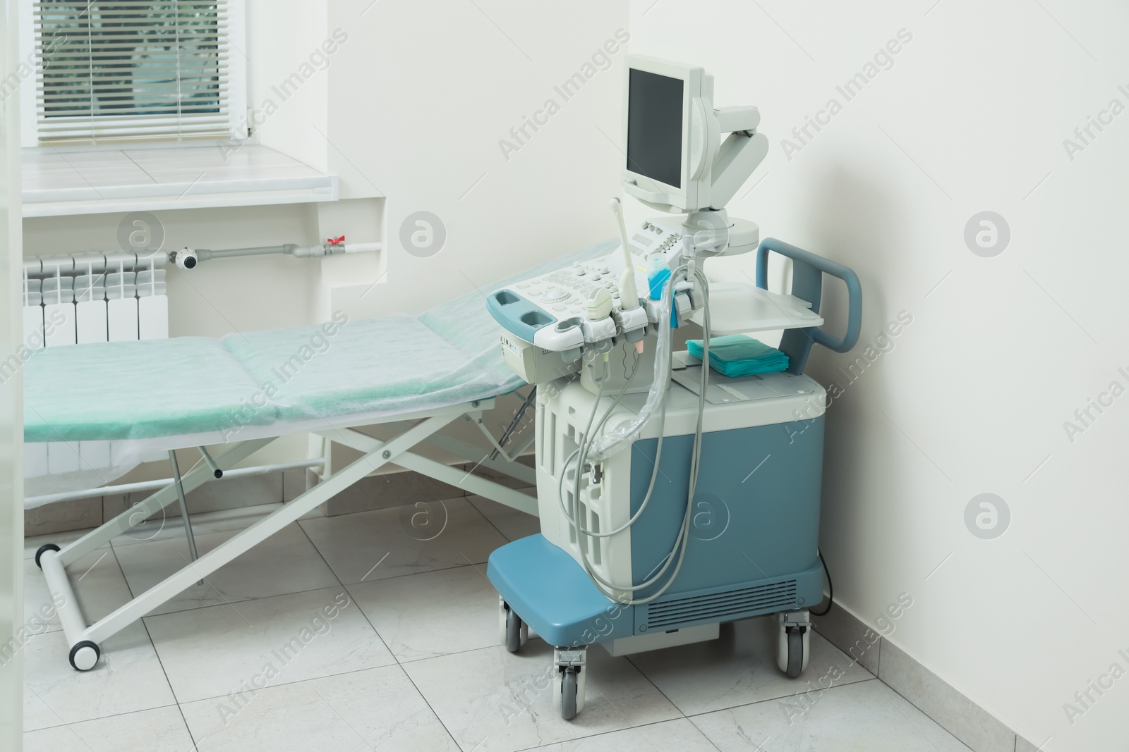 Photo of Ultrasound machine and examination table in hospital