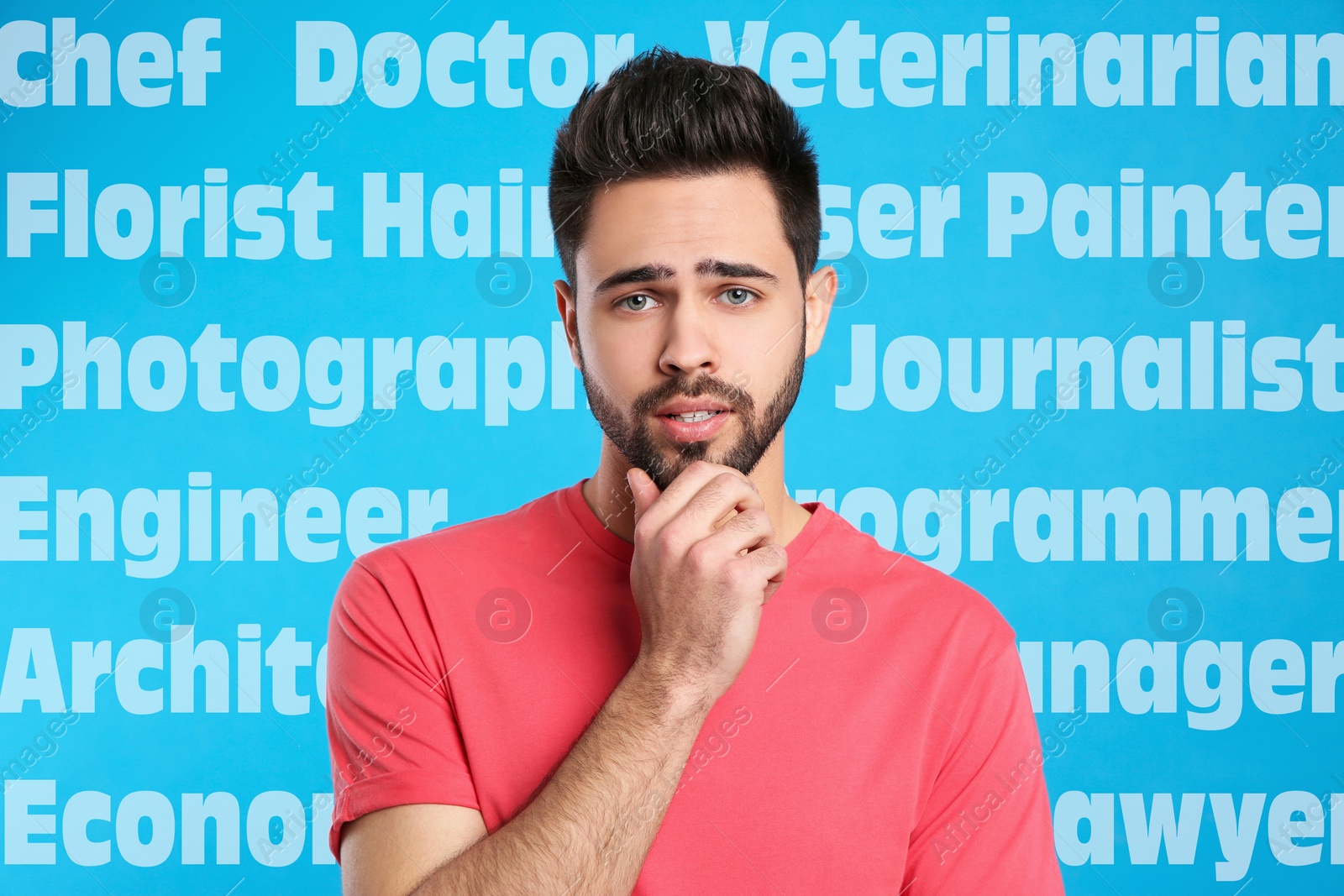 Image of Puzzled young man choosing profession on blue background