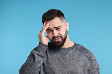 Photo of Portrait of sad man on light blue background