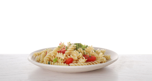Tasty pasta with broccoli and cherry tomatoes on wooden table against white background
