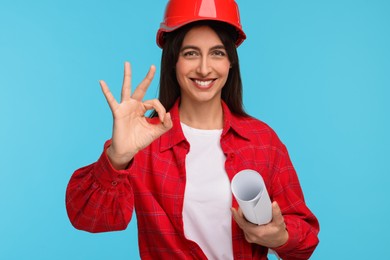 Architect in hard hat with draft on light blue background