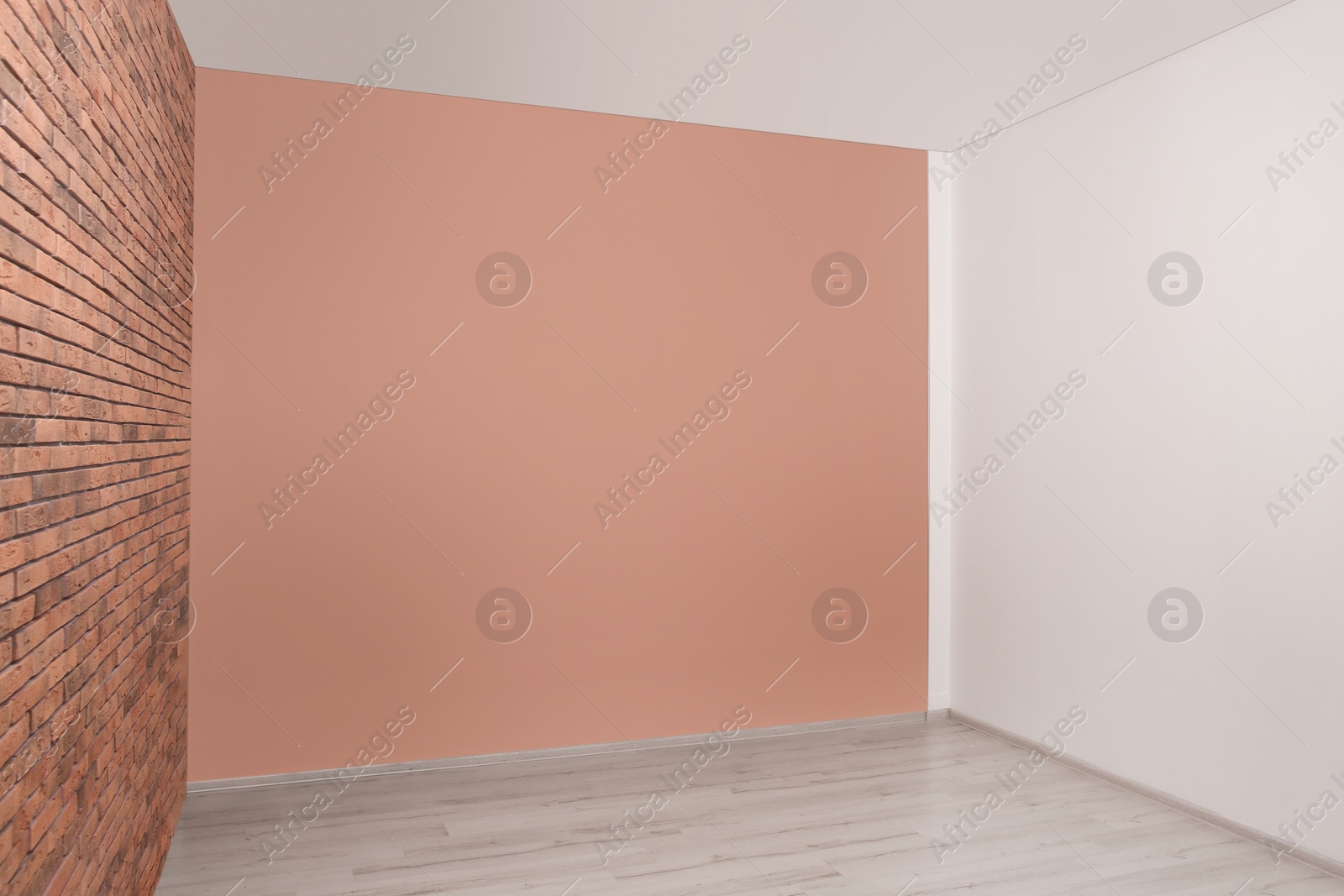 Photo of Empty room with different walls and laminated floor