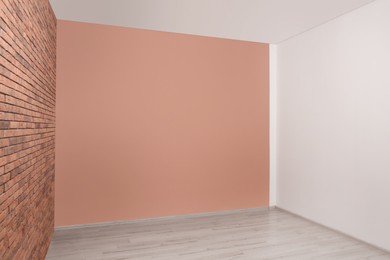 Empty room with different walls and laminated floor