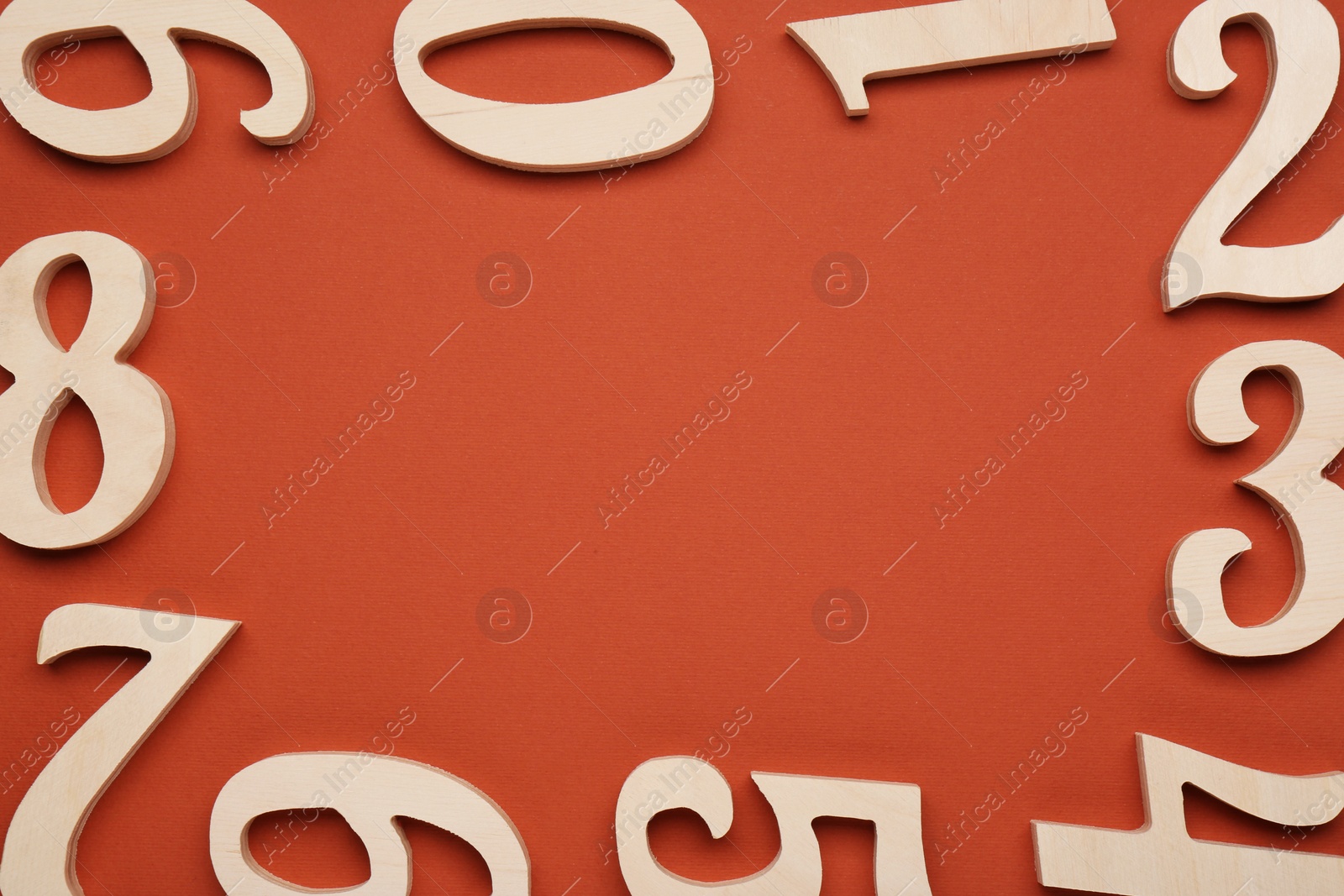 Photo of Frame made of wooden numbers on brown background, flat lay. Space for text