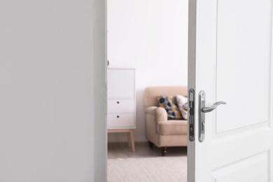 Room interior with new furniture, view through open door