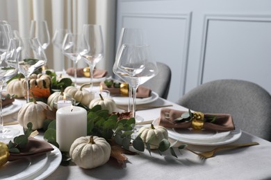 Photo of Beautiful autumn table setting. Plates, cutlery, glasses and floral decor indoors