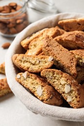 Traditional Italian almond biscuits (Cantucci) in basket on table, closeup