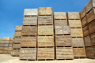 Pile of empty wooden crates outdoors on sunny day