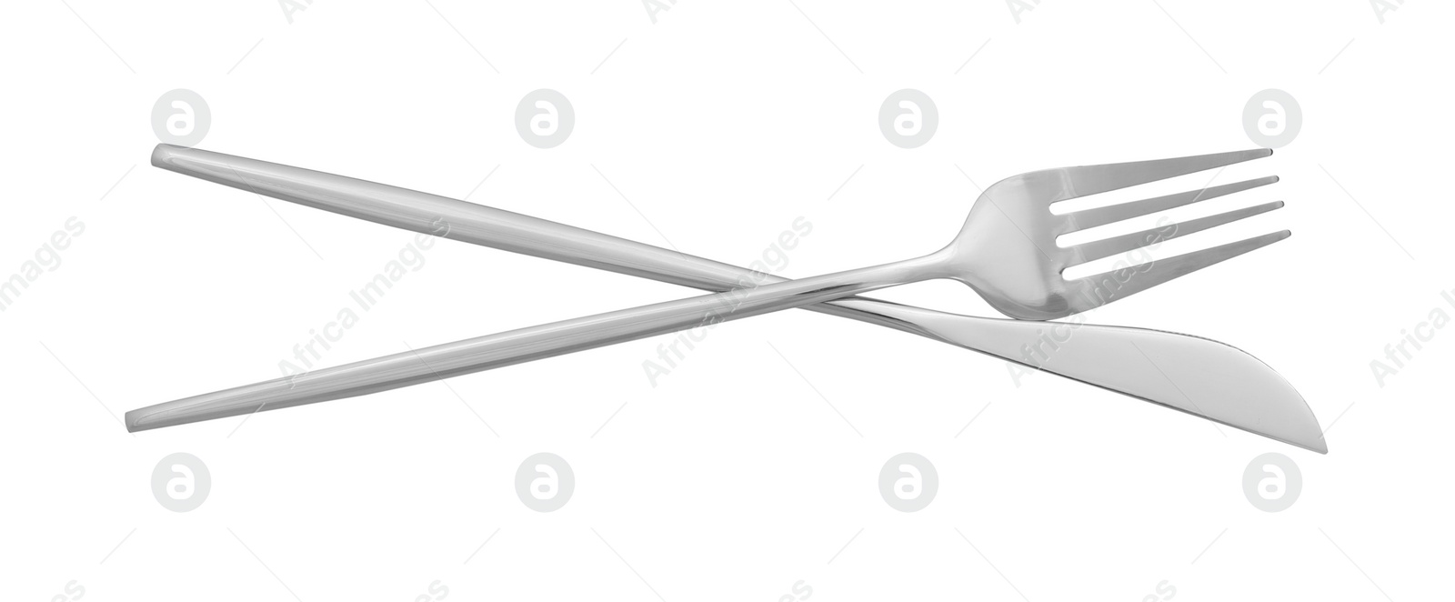 Photo of Knife and fork isolated on white, top view. Stylish shiny cutlery set