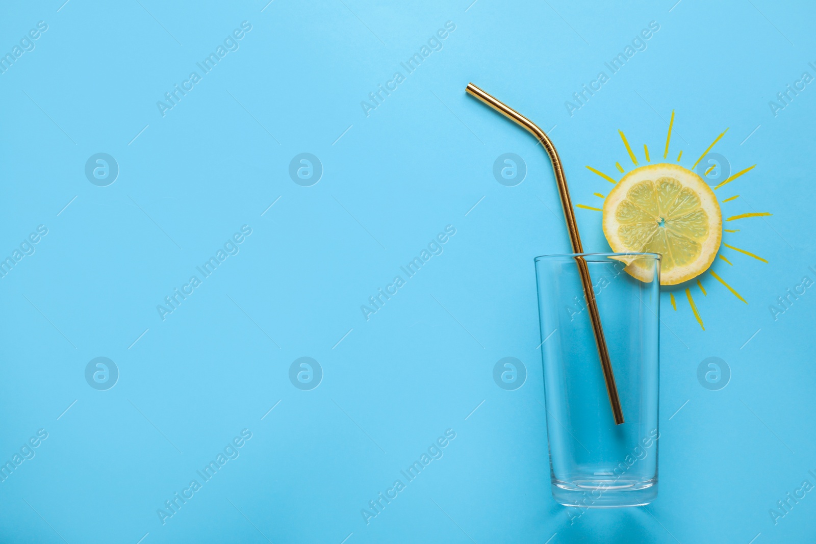 Photo of Composition of citrus slice as sun, straw and glass on color background, top view with space for text. Summer cocktail