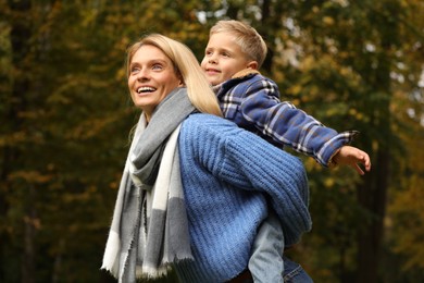 Photo of Happy mother with her son in autumn park