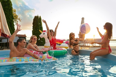 Photo of Group of happy people enjoying fun pool party