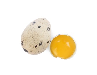 Photo of Whole and cracked quail eggs on white background, top view