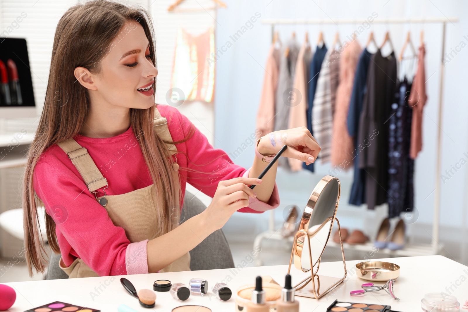 Photo of Beauty blogger doing eyeshadow swatches at home