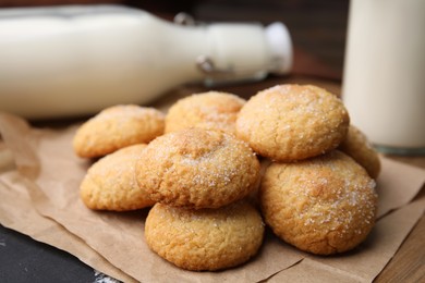 Photo of Tasty sweet sugar cookies and milk on wooden table, closeup