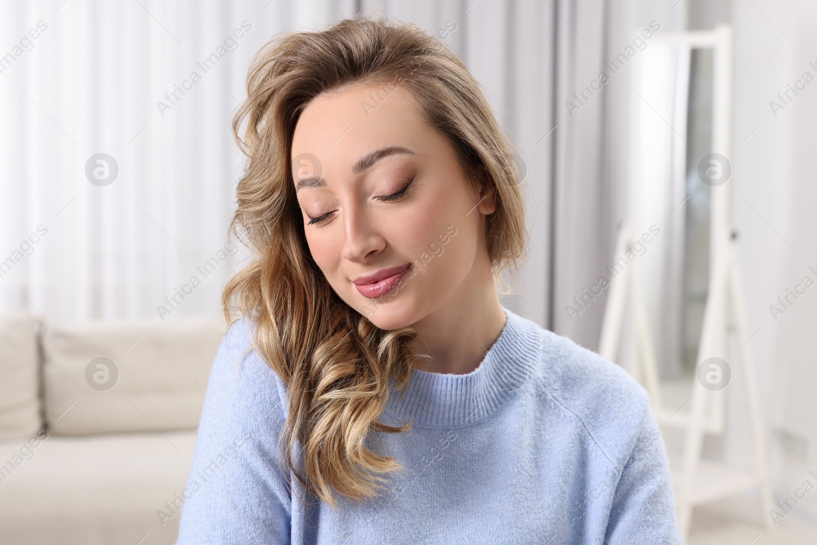 Photo of Portrait of beautiful woman with curly hair at home