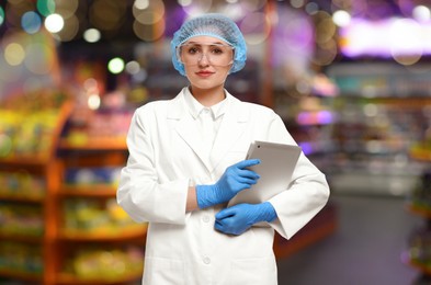 Image of Food quality control specialist examining products in supermarket