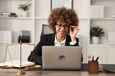 Photo of Notary using laptop at workplace in office