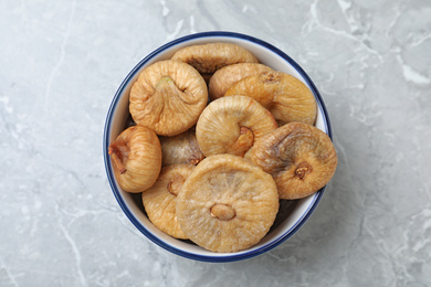 Photo of Tasty dried figs on light grey marble table, top view