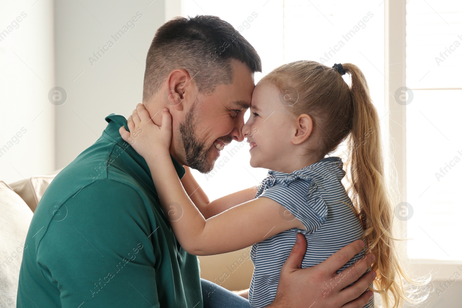 Photo of Dad and daughter spending time together at home. Happy Father's Day