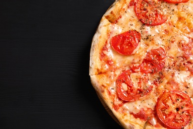 Hot cheese pizza Margherita on wooden table, top view. Space for text