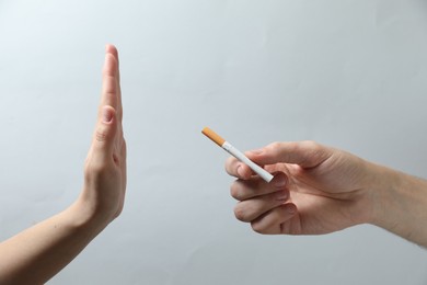 Photo of Man refusing cigarette on grey background, closeup