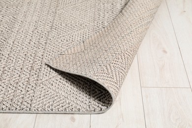 Photo of Soft grey carpet on white laminated floor indoors