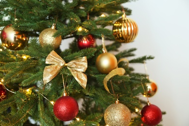 Beautiful Christmas tree with fairy lights and festive decor, closeup