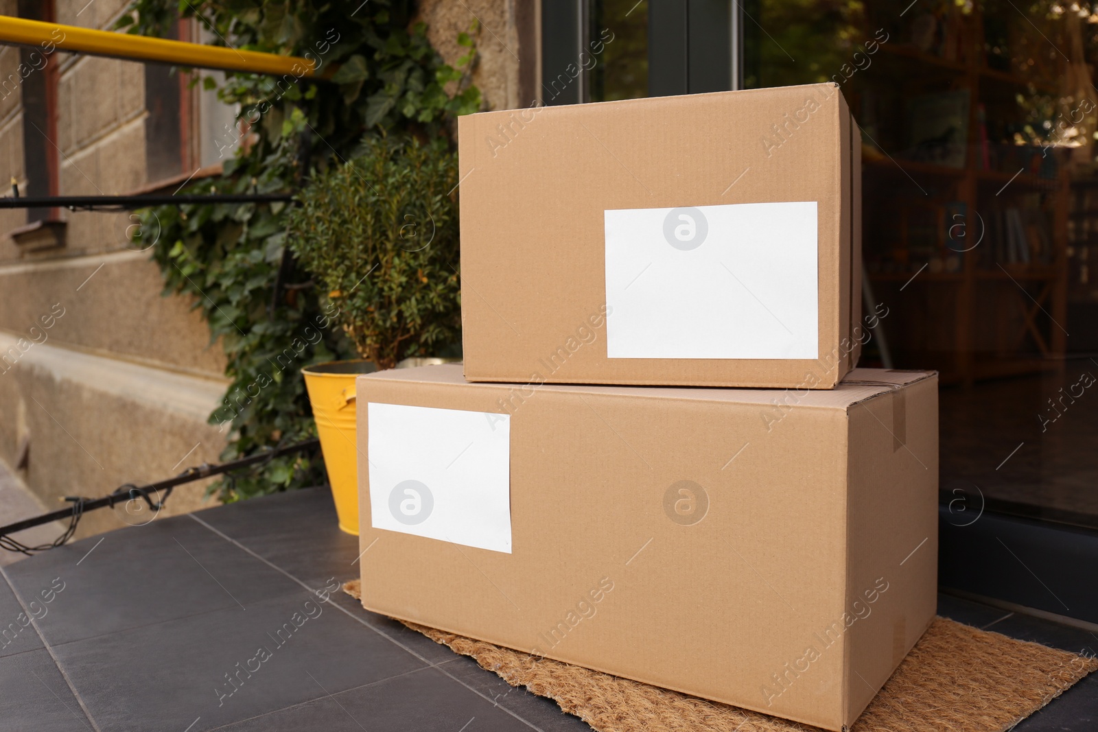 Photo of Delivered parcels on door mat near entrance