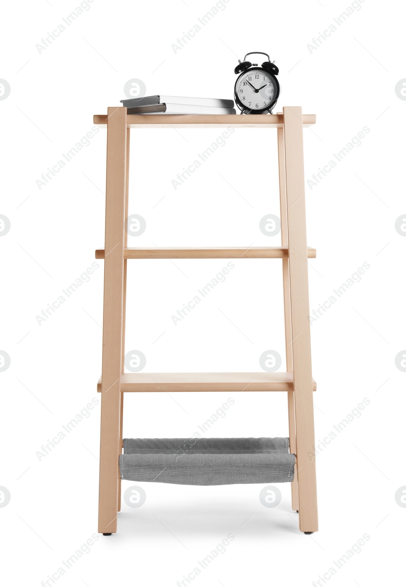 Photo of Stylish shelving unit with books and alarm clock isolated on white