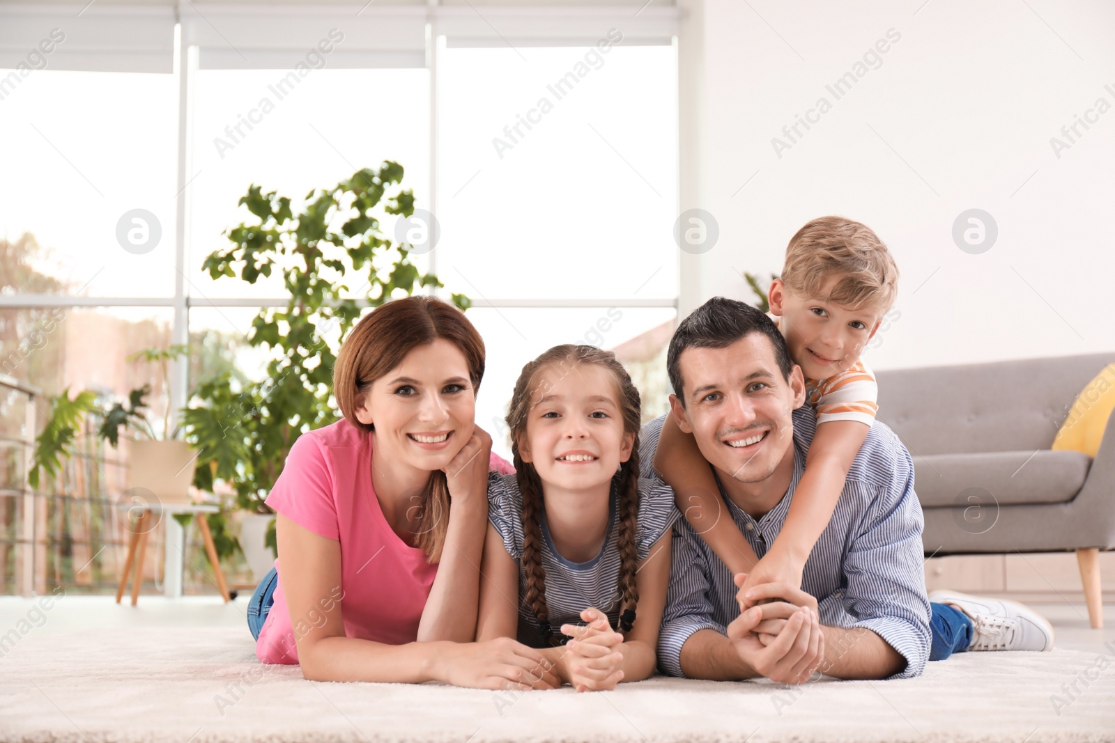 Photo of Happy family with cute children at home
