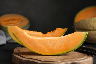 Slices of tasty fresh melon on wooden board, closeup