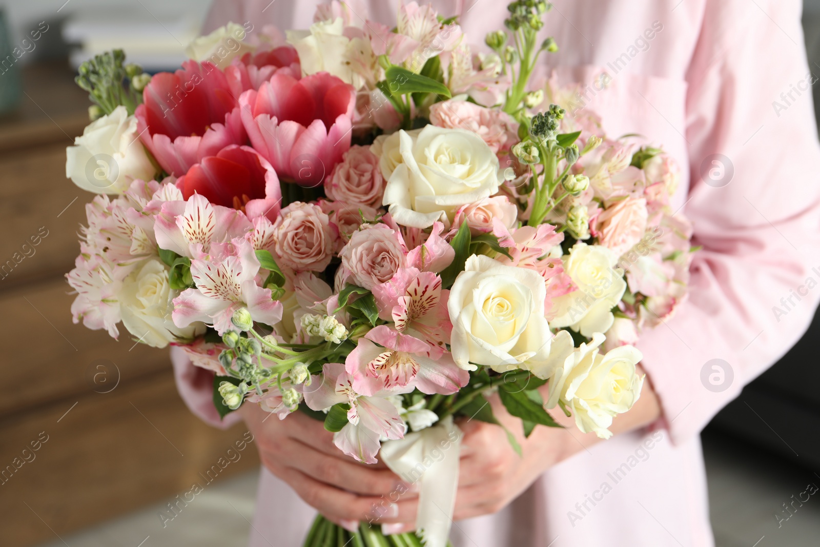 Photo of Woman with beautiful bouquet of fresh flowers indoors, closeup